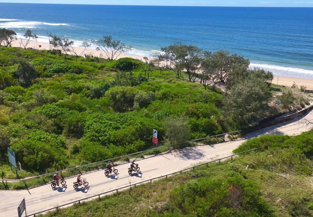 Noosa beach rides. Riders riding onto the beach