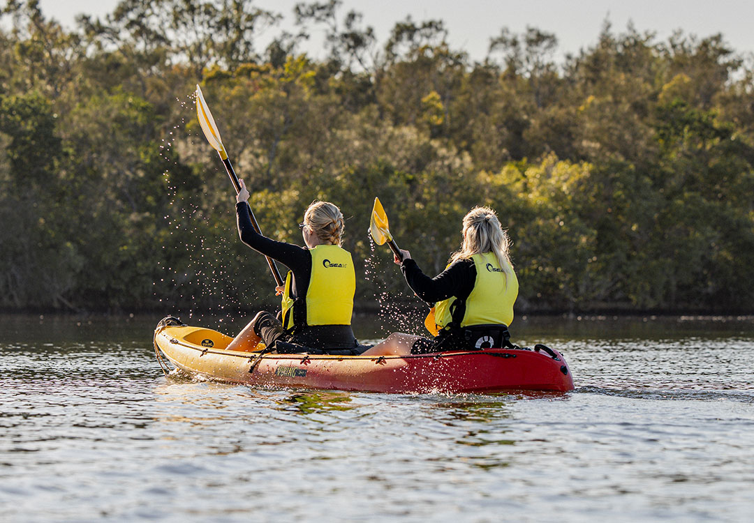 Friends preparing for a self-guided kayaking adventure in Noosa