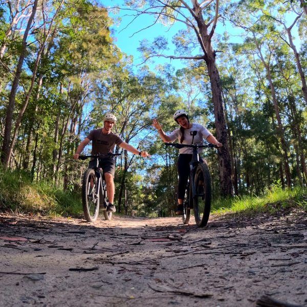 Two riders on a forest mountain bike trail, Noosa Hinterland