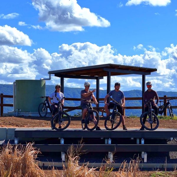 Group of riders with their bikes at a hinterland lookout shelter